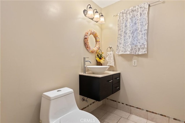 bathroom featuring tile patterned flooring, vanity, and toilet