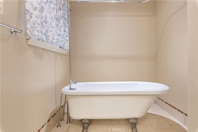 bathroom with tile patterned floors and a tub