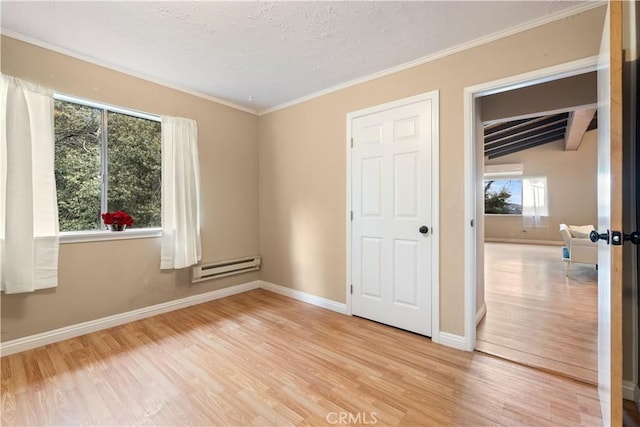 unfurnished bedroom featuring light hardwood / wood-style floors, baseboard heating, and multiple windows