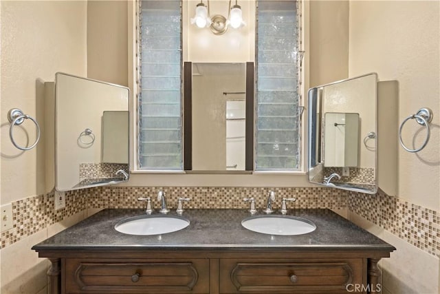 bathroom featuring decorative backsplash and vanity