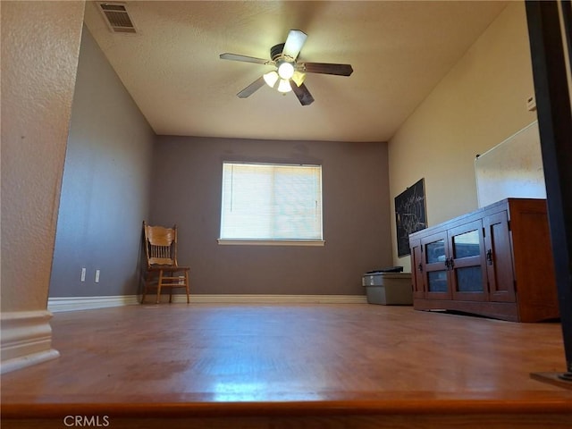 unfurnished living room with ceiling fan