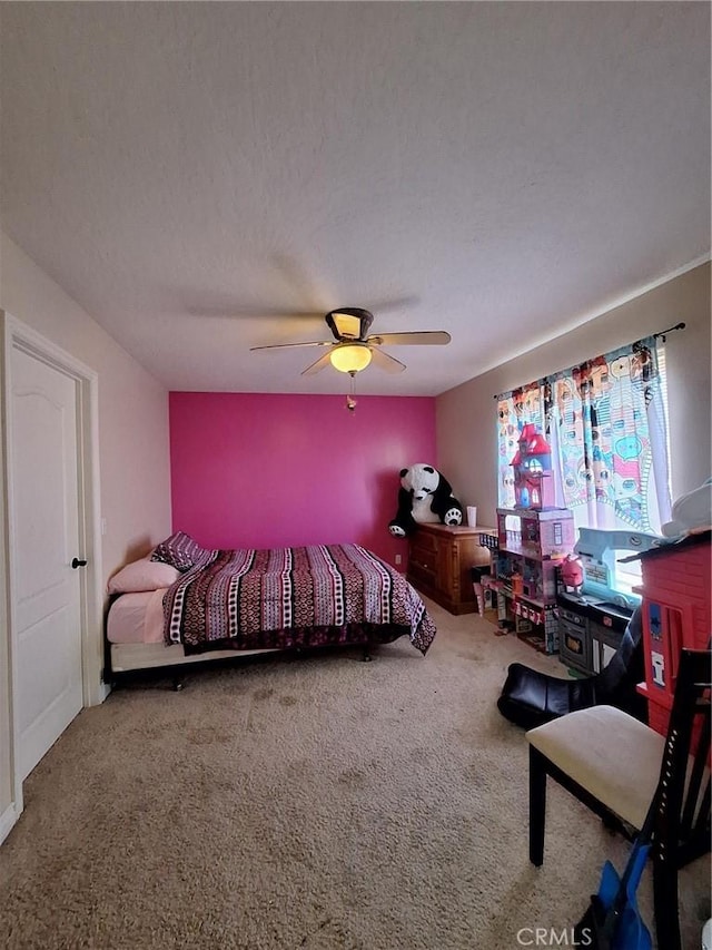 bedroom featuring a textured ceiling, ceiling fan, and carpet floors