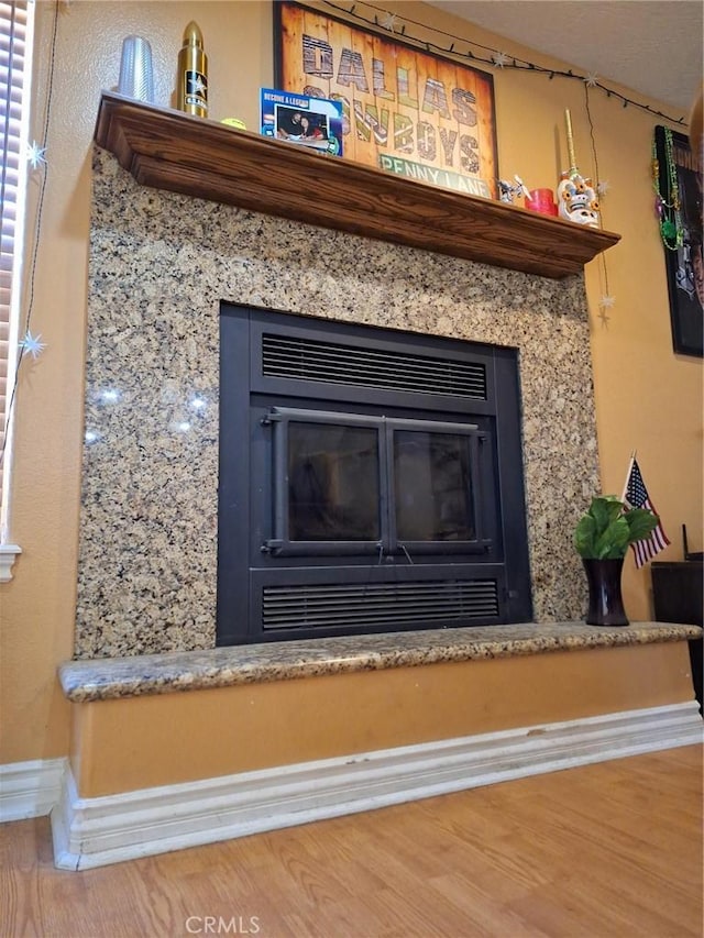 room details featuring hardwood / wood-style floors and a fireplace