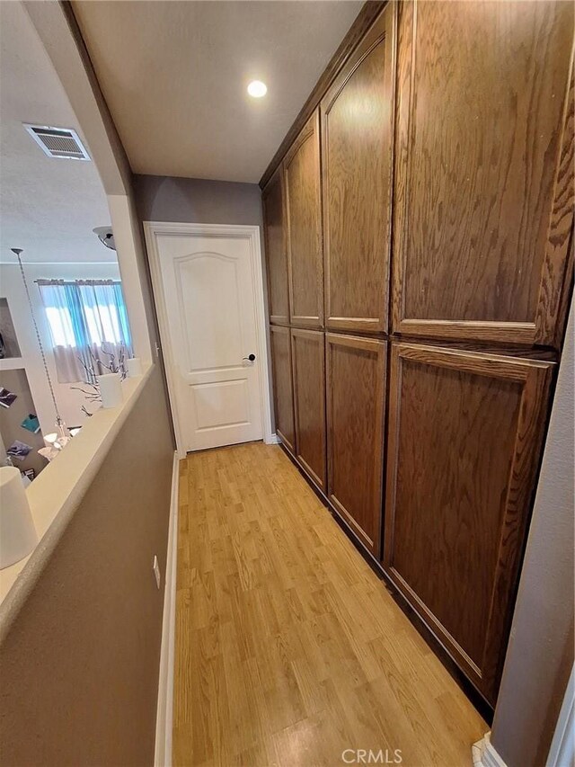 corridor featuring light hardwood / wood-style floors