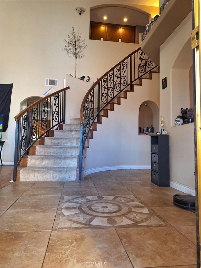 stairway with a towering ceiling