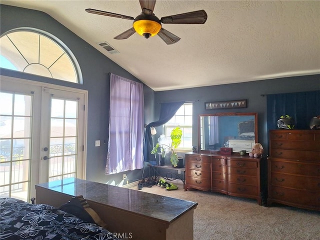 carpeted bedroom with ceiling fan, lofted ceiling, access to outside, a textured ceiling, and french doors