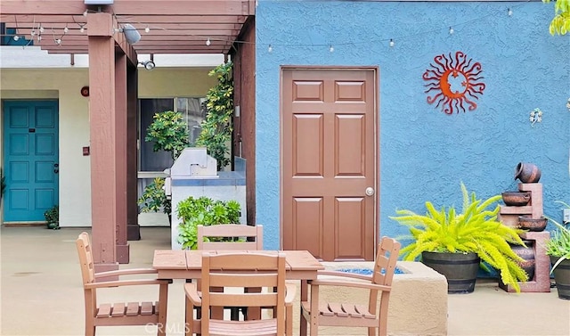 doorway to property with a pergola