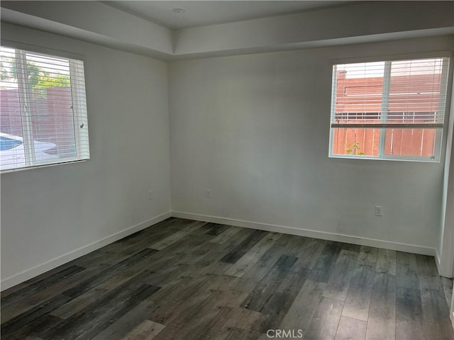 empty room featuring dark wood-type flooring