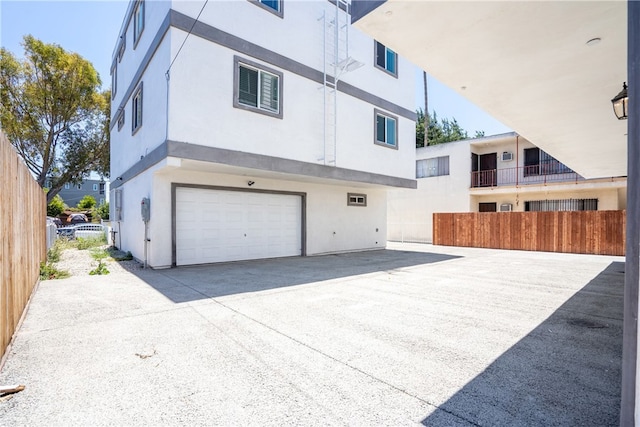 exterior space featuring a balcony and a garage