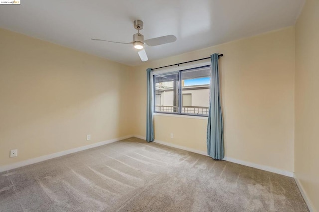 carpeted spare room with ceiling fan