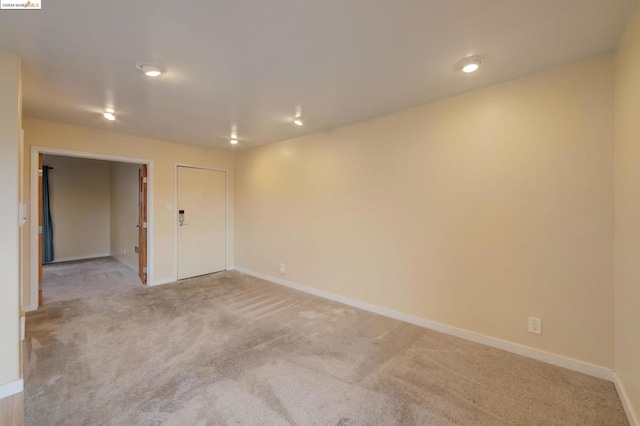 unfurnished room with light carpet