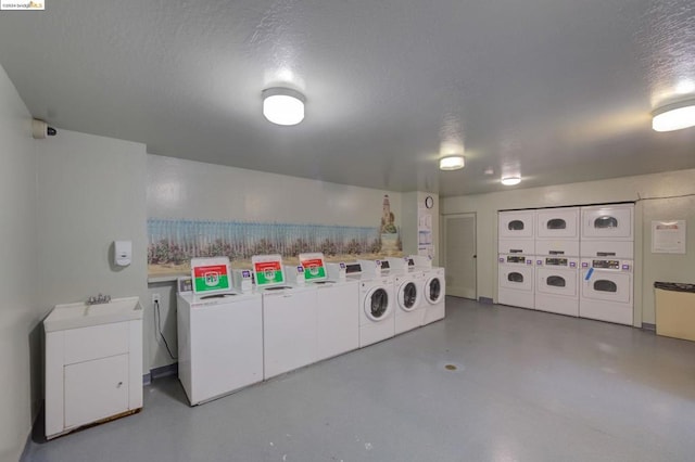 clothes washing area with sink, stacked washing maching and dryer, a textured ceiling, and independent washer and dryer