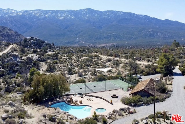 birds eye view of property with a mountain view