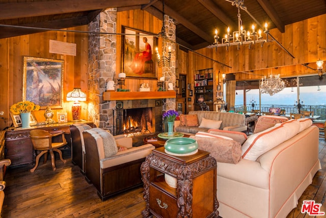 living room featuring beam ceiling, dark wood-type flooring, a stone fireplace, wooden walls, and wood ceiling