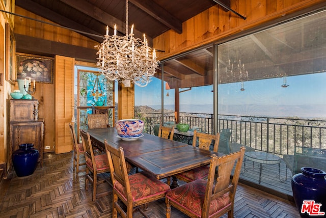 dining space featuring vaulted ceiling with beams, dark parquet floors, a notable chandelier, wooden walls, and wood ceiling