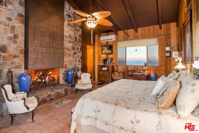 tiled bedroom with beam ceiling, an AC wall unit, wooden ceiling, a stone fireplace, and wood walls