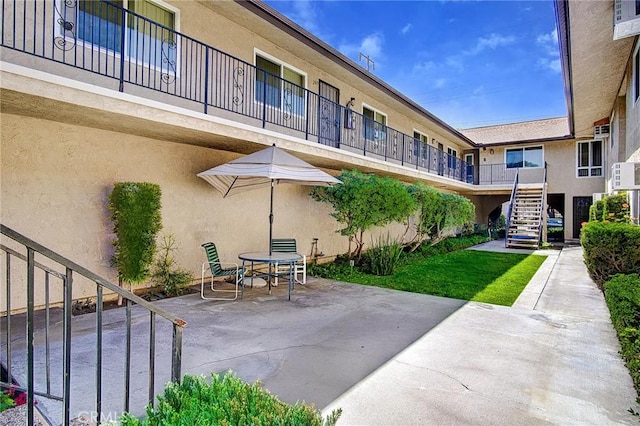 view of property's community featuring a patio area and stairway