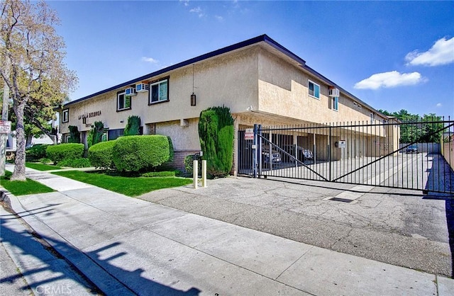 view of front of property featuring fence and stucco siding