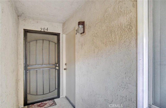 property entrance featuring stucco siding