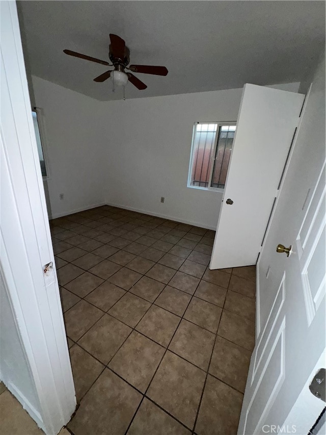 tiled empty room with ceiling fan