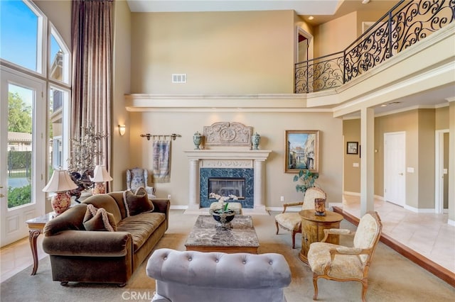 interior space with a wealth of natural light, a premium fireplace, and a high ceiling