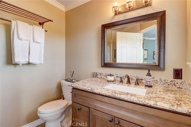 bathroom featuring crown molding, vanity, and toilet