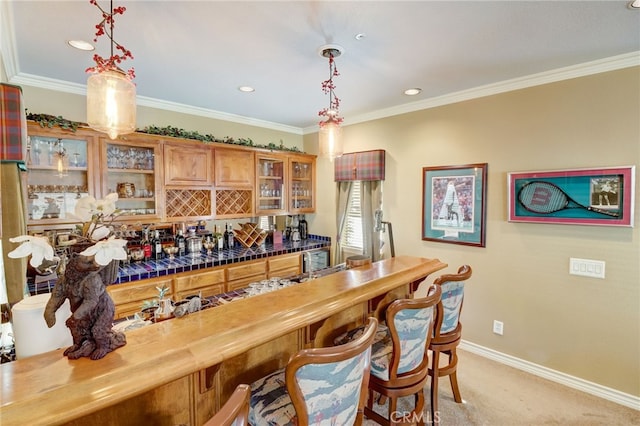 bar featuring butcher block counters, light carpet, hanging light fixtures, and ornamental molding