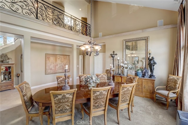 dining room featuring carpet flooring, high vaulted ceiling, and a chandelier