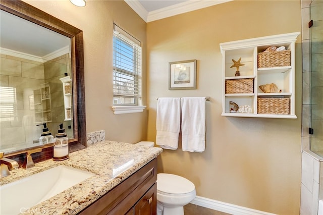 bathroom with vanity, toilet, crown molding, and walk in shower