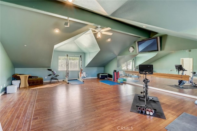 workout room featuring hardwood / wood-style flooring, vaulted ceiling, and ceiling fan