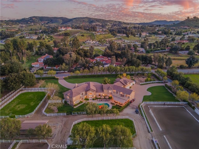 aerial view at dusk featuring a mountain view