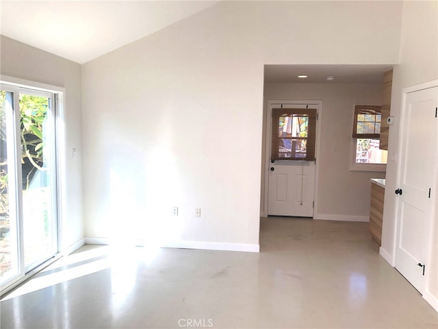 empty room featuring vaulted ceiling