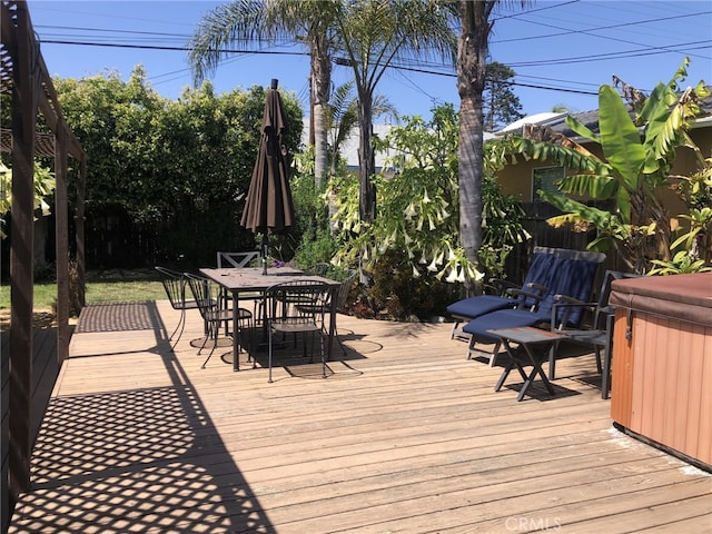 wooden deck with a hot tub