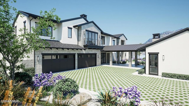 view of front of property with a front lawn, a garage, and a balcony