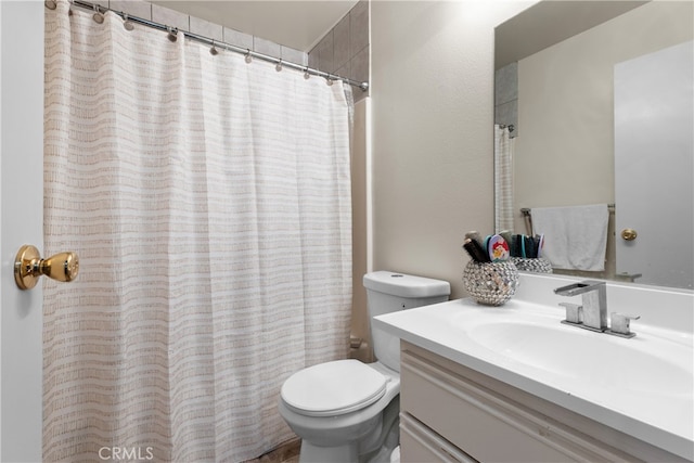 bathroom featuring vanity, toilet, and a shower with shower curtain