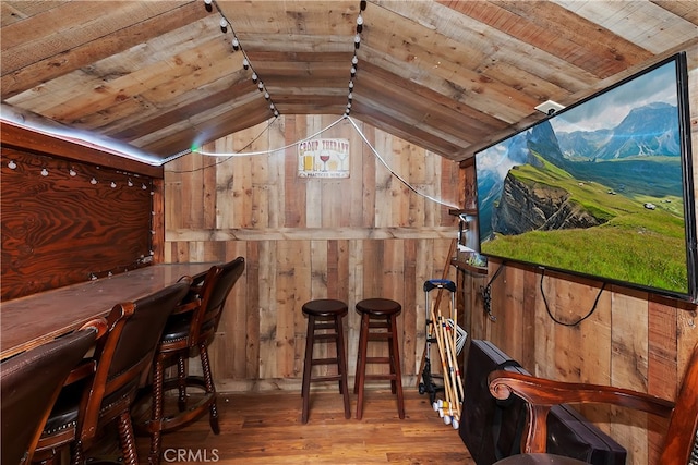 interior space featuring wood ceiling, wooden walls, lofted ceiling, and hardwood / wood-style floors