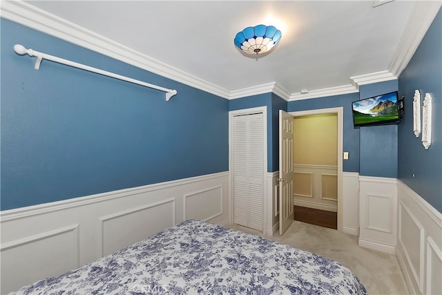 bedroom featuring light colored carpet, a closet, and crown molding