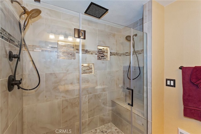 bathroom with a shower with door