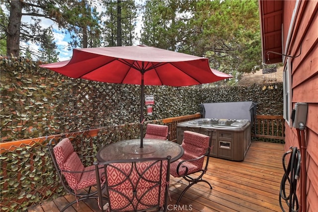 wooden terrace featuring a hot tub