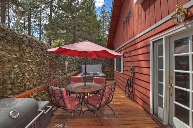 wooden deck featuring a grill