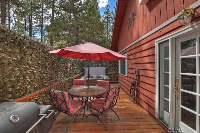 deck with grilling area, french doors, and outdoor dining area