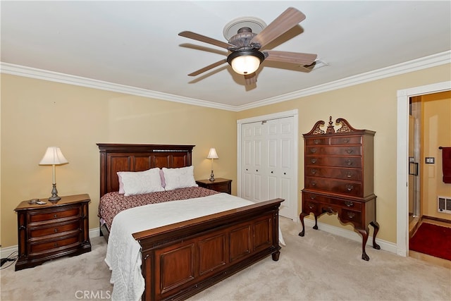 bedroom featuring ceiling fan, light colored carpet, a closet, and crown molding