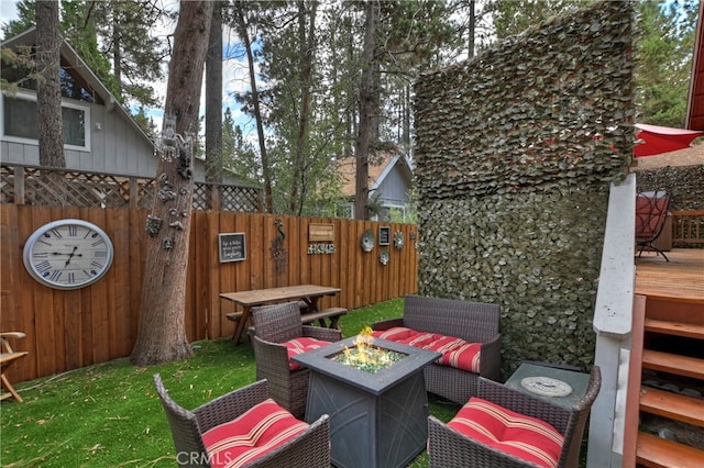 view of patio with an outdoor fire pit and a deck