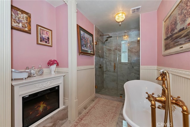 bathroom with shower with separate bathtub and tile patterned floors