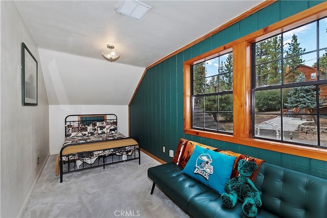 living area featuring light carpet and vaulted ceiling