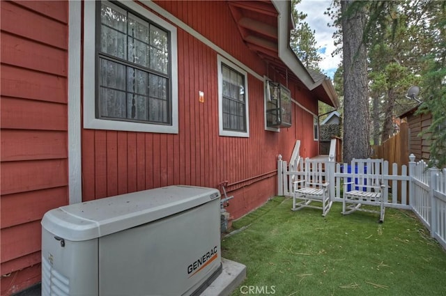 view of side of property with fence and a yard