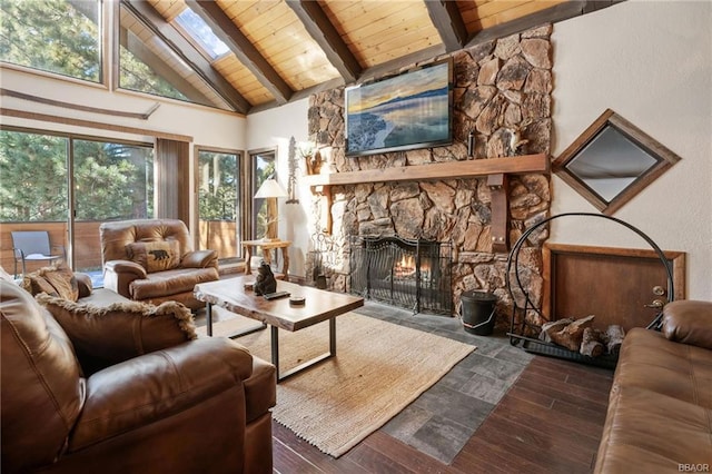 living room featuring high vaulted ceiling, a skylight, a fireplace, and dark hardwood / wood-style flooring