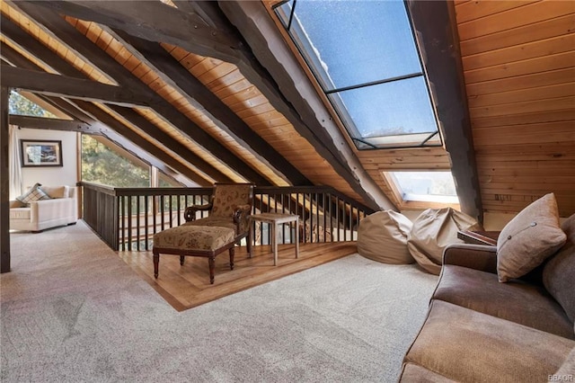 interior space featuring wood walls, lofted ceiling with skylight, carpet, and wooden ceiling