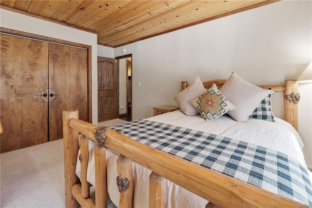 carpeted bedroom featuring a closet and wood ceiling