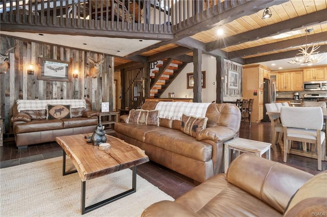 living room with beamed ceiling, wooden ceiling, hardwood / wood-style floors, an inviting chandelier, and wood walls